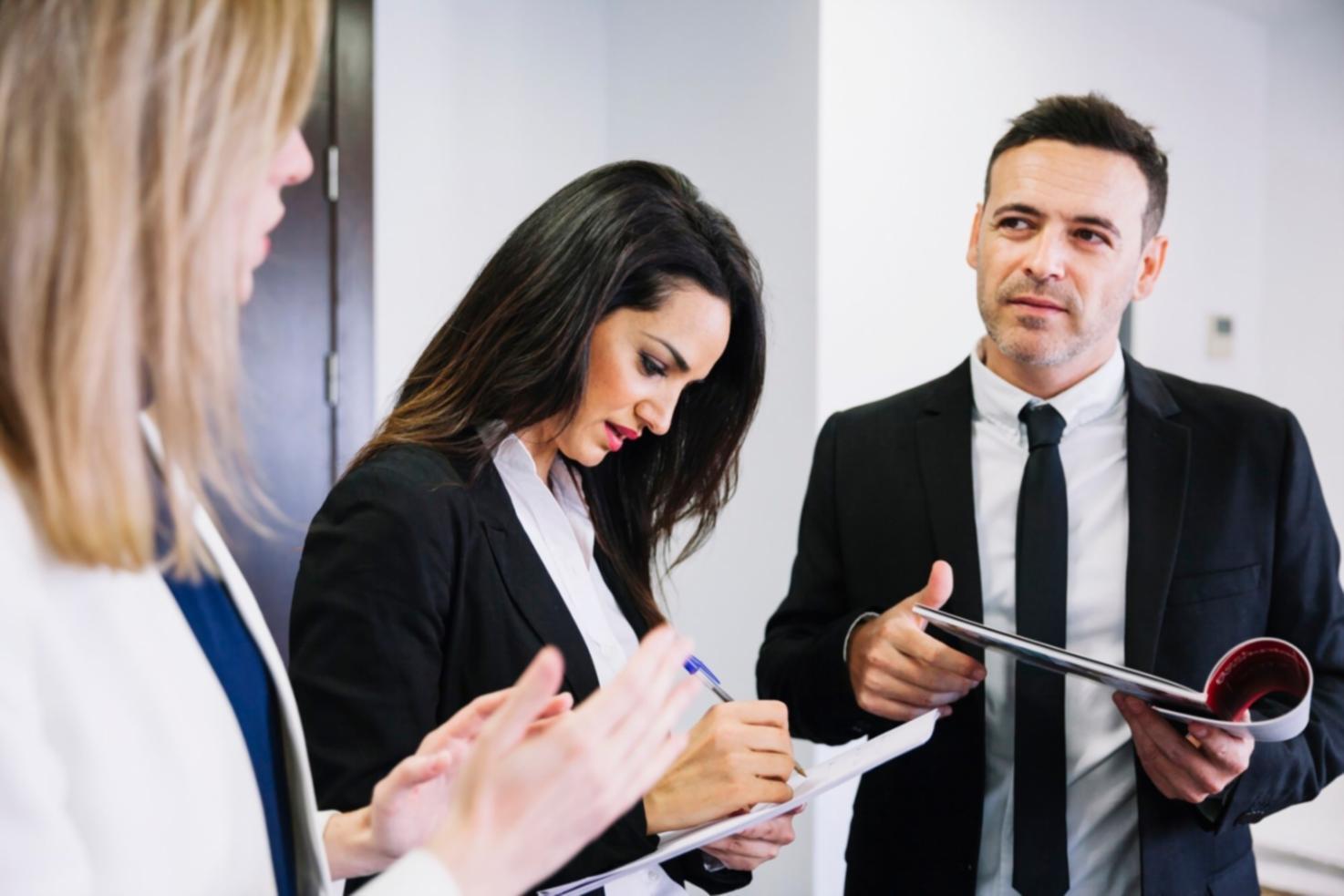 Business team collaborating on financial analysis in a modern meeting room